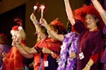 Red Hatters Shaking Maracas On Stage With Rick Hubbard